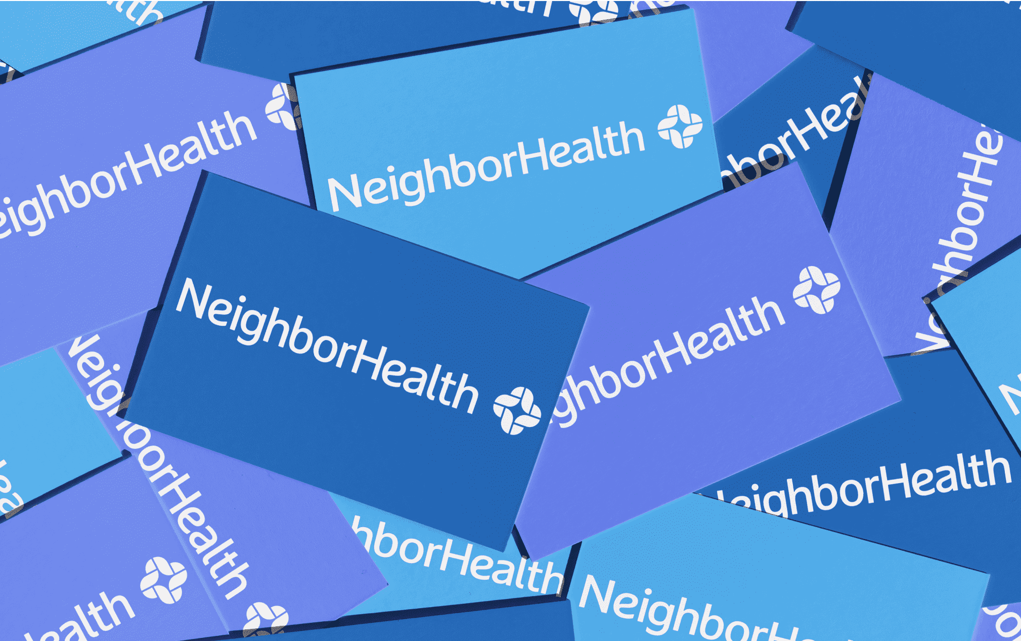 A pile of overlapping business cards displaying the "NeighborHealth" logo in white text on varying shades of blue backgrounds.