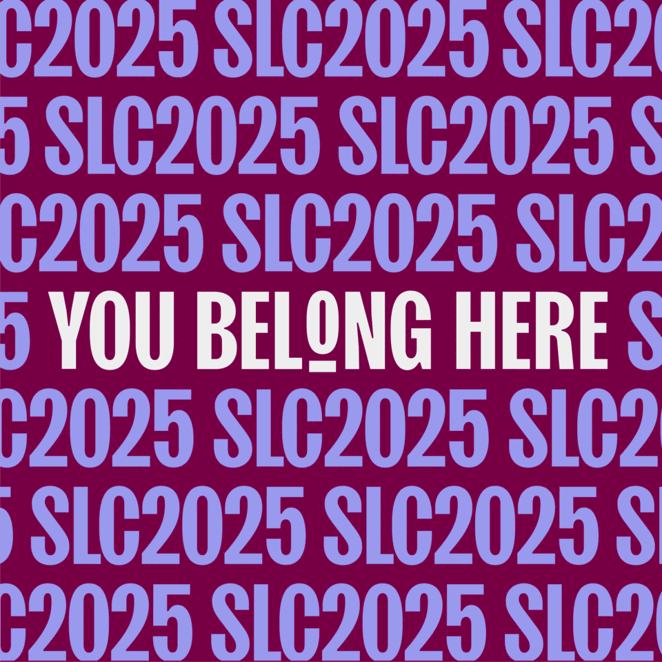 Bold white text reads "YOU BELONG HERE" centered on a maroon background, overlaid by repeated blue text "SLC2025" in a pattern.